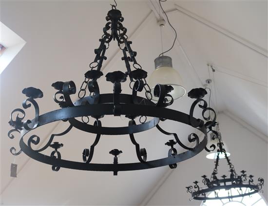 A pair of wrought iron chandeliers